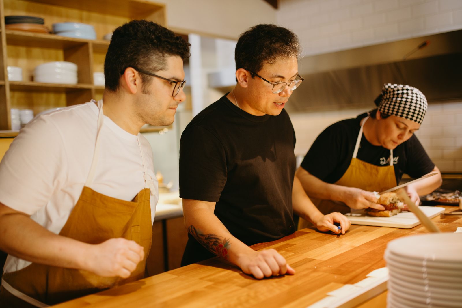 Hospitality team collaborating behind the scenes in a restaurant kitchen